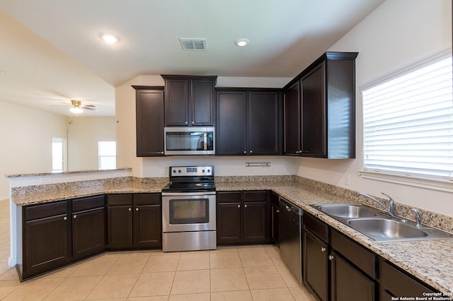 kitchen featuring appliances with stainless steel finishes, a wealth of natural light, ceiling fan, and sink