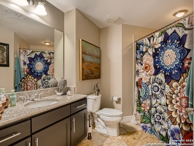 215 Center St Unit 307, San Antonio, TX 78202 - full bathroom featuring toilet, vanity, tile patterned flooring, and a shower with curtain