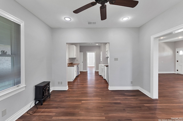 interior space featuring dark wood-type flooring and ceiling fan