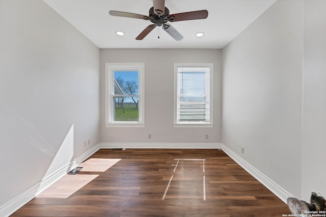 empty room with dark wood-type flooring and ceiling fan