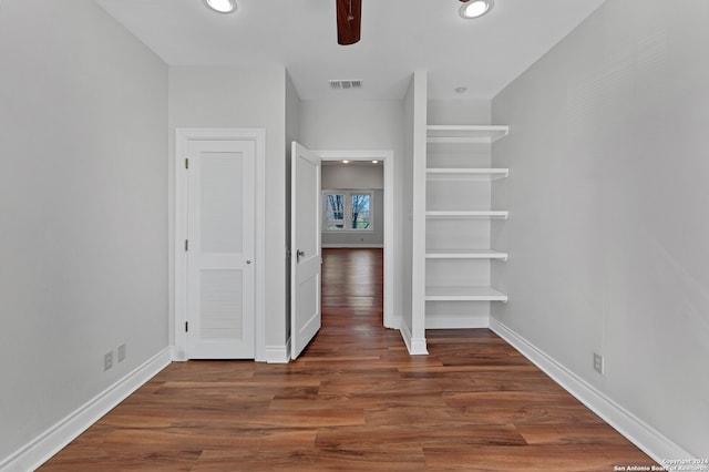 unfurnished bedroom featuring dark wood-type flooring and ceiling fan