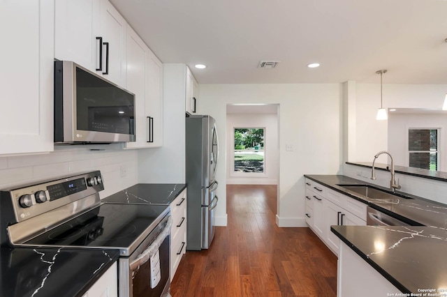 kitchen with sink, white cabinetry, and stainless steel appliances