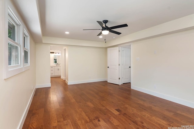 empty room featuring ceiling fan and dark hardwood / wood-style floors