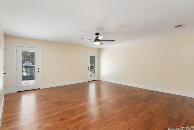 spare room featuring hardwood / wood-style floors and ceiling fan