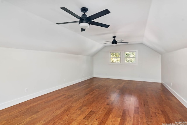 additional living space featuring ceiling fan, wood-type flooring, and vaulted ceiling