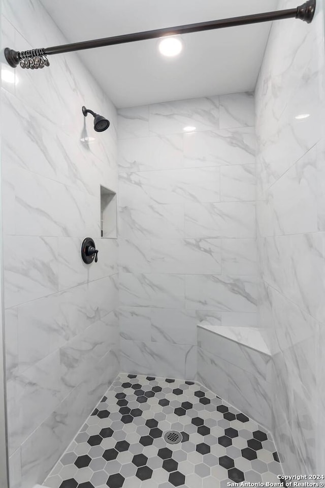 bathroom with a tile shower