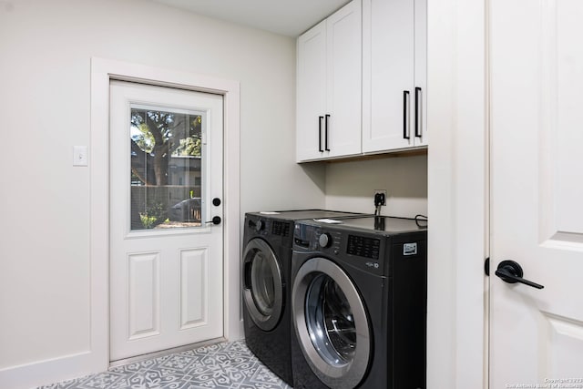 clothes washing area featuring cabinets, separate washer and dryer, and light tile patterned flooring