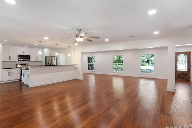 unfurnished living room with ceiling fan and dark hardwood / wood-style floors