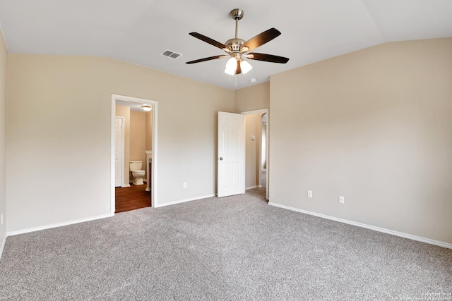 unfurnished bedroom with ensuite bath, ceiling fan, carpet, and vaulted ceiling