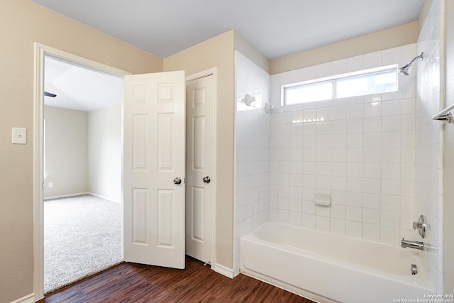 bathroom featuring hardwood / wood-style floors and tiled shower / bath combo