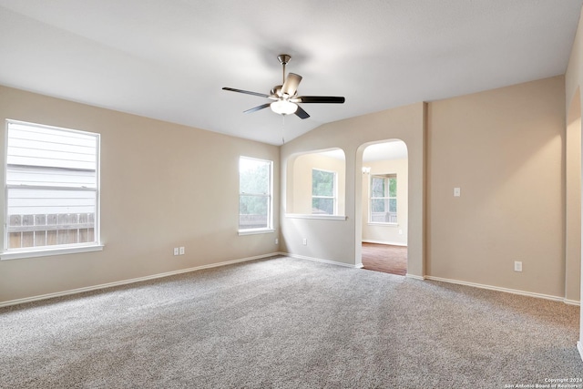 unfurnished room featuring carpet, ceiling fan, and vaulted ceiling