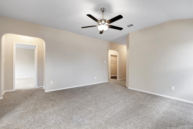 empty room featuring carpet flooring, ceiling fan, and vaulted ceiling