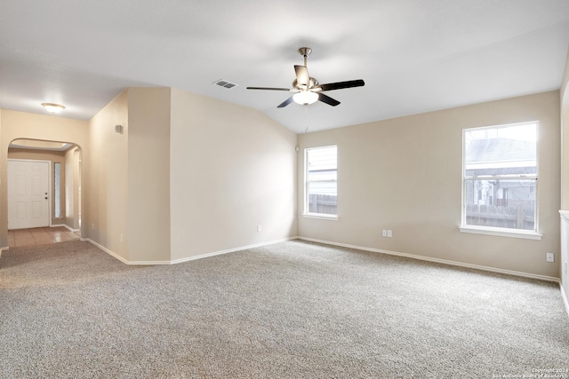 spare room featuring light colored carpet, ceiling fan, and lofted ceiling