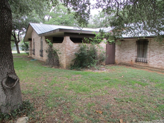 view of property exterior with a yard