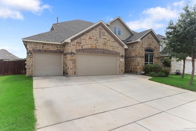 view of front facade featuring a garage and a front lawn