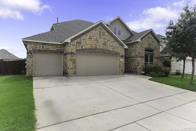 view of front facade with a garage and a front yard