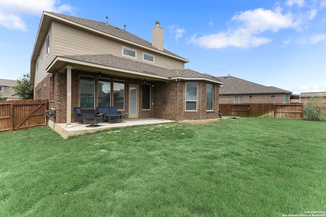 rear view of property featuring a patio area and a yard