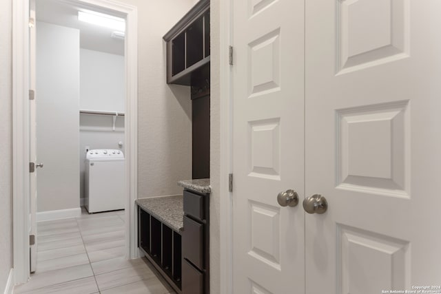 mudroom with light tile patterned floors and washer / dryer