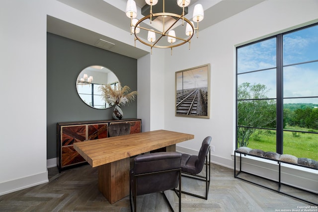 dining room featuring dark parquet floors and a chandelier