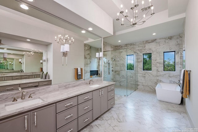 bathroom featuring a notable chandelier, separate shower and tub, tile walls, and vanity