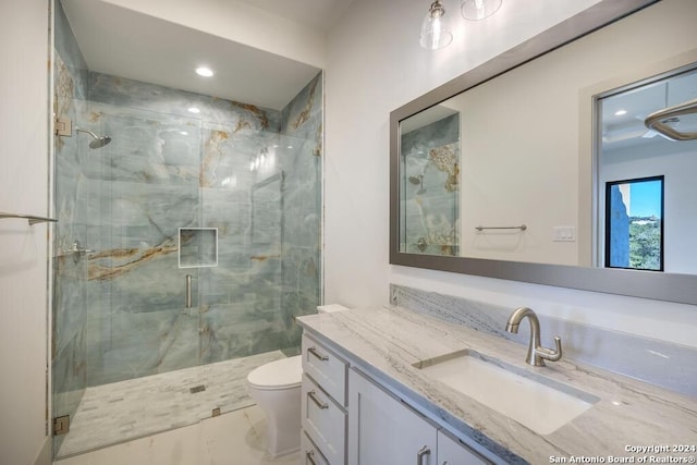 bathroom featuring vanity, an enclosed shower, and toilet