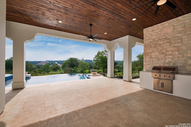 view of patio with pool water feature, ceiling fan, area for grilling, and a grill