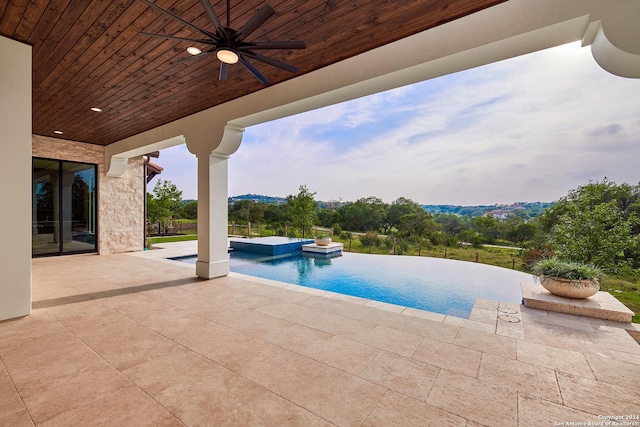 view of swimming pool with a patio, a hot tub, and ceiling fan