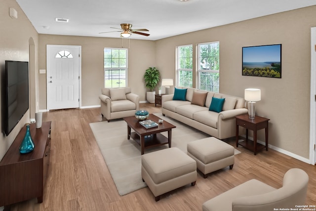 living room with light hardwood / wood-style flooring and ceiling fan