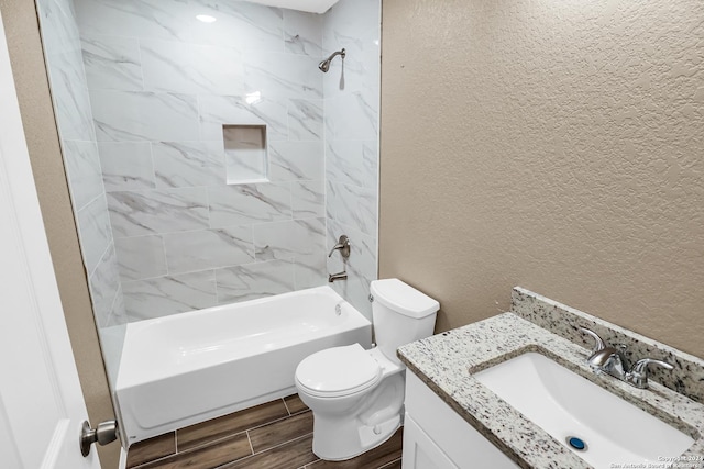 full bathroom featuring vanity, toilet, and tiled shower / bath