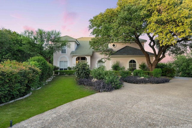 mediterranean / spanish-style home featuring a yard