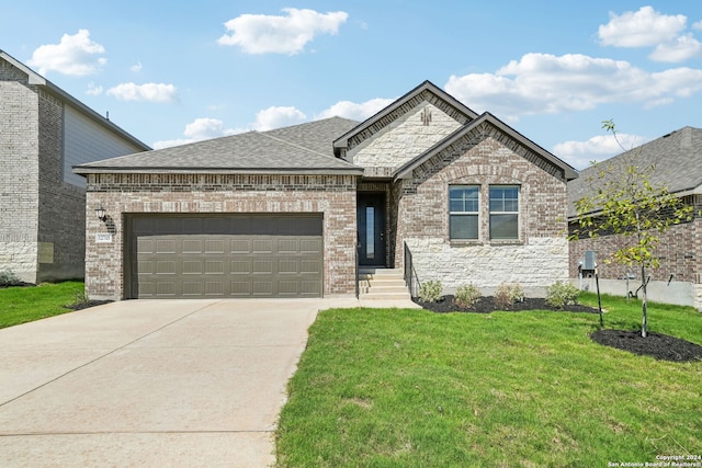 view of front of property with a front yard and a garage