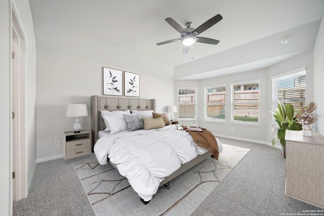 bedroom featuring ceiling fan and light carpet