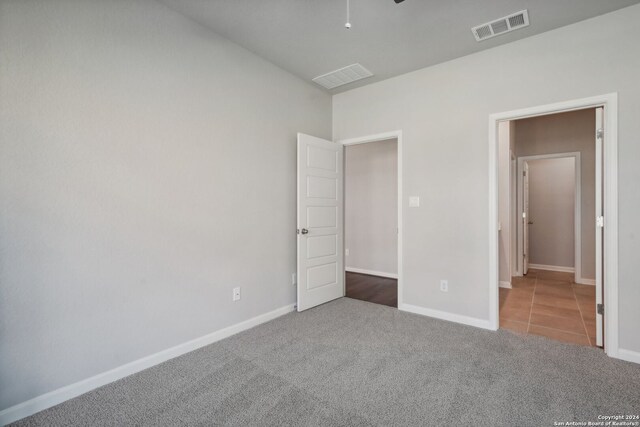 unfurnished bedroom with carpet flooring