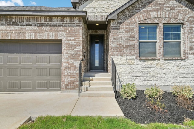 doorway to property with a garage