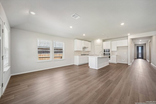 unfurnished living room featuring dark hardwood / wood-style flooring and sink