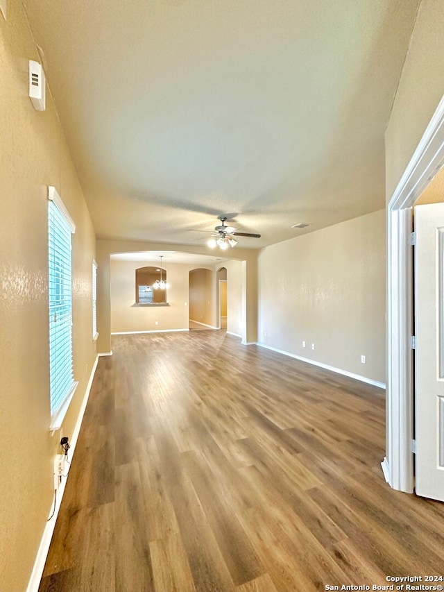 unfurnished living room with hardwood / wood-style floors and ceiling fan