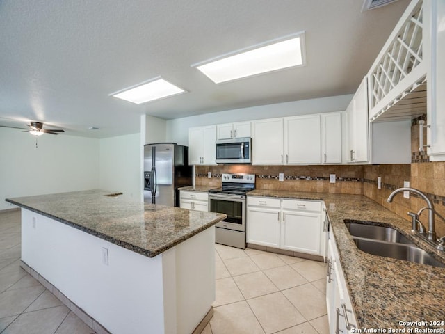 kitchen featuring white cabinets, light tile patterned flooring, sink, and stainless steel appliances