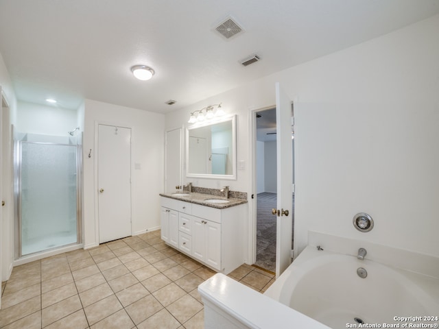 bathroom with tile patterned flooring, vanity, and independent shower and bath