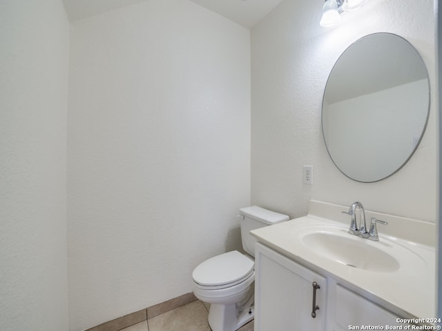 bathroom with tile patterned flooring, vanity, and toilet