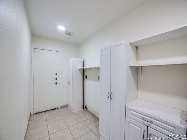 laundry room with light tile patterned floors and hookup for an electric dryer