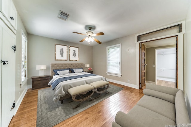 bedroom with light hardwood / wood-style floors and ceiling fan