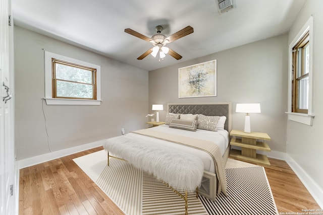 bedroom with ceiling fan and light wood-type flooring