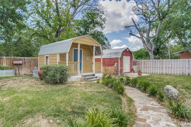 view of front of home with a shed and a front yard