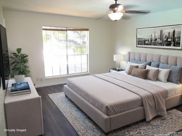 bedroom with baseboards and dark wood finished floors