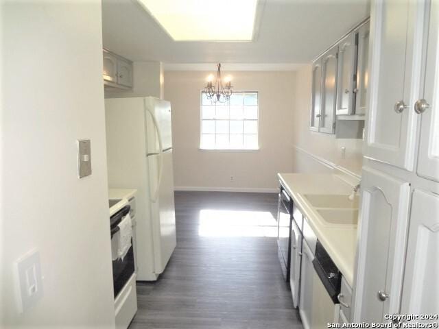 kitchen featuring stove, sink, white refrigerator, dishwasher, and gray cabinets