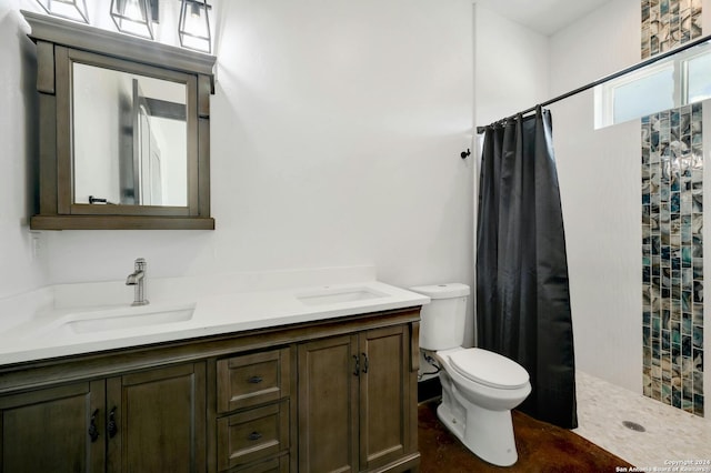 bathroom featuring dual vanity, a shower with curtain, and toilet