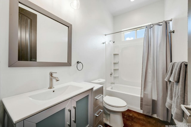 full bathroom with vanity, shower / bath combo, and toilet