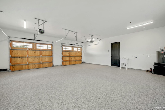 garage with water heater and a garage door opener