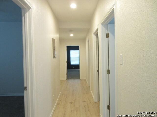 hallway with light hardwood / wood-style flooring