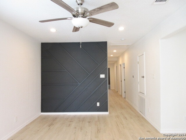 unfurnished room featuring ceiling fan and light wood-type flooring